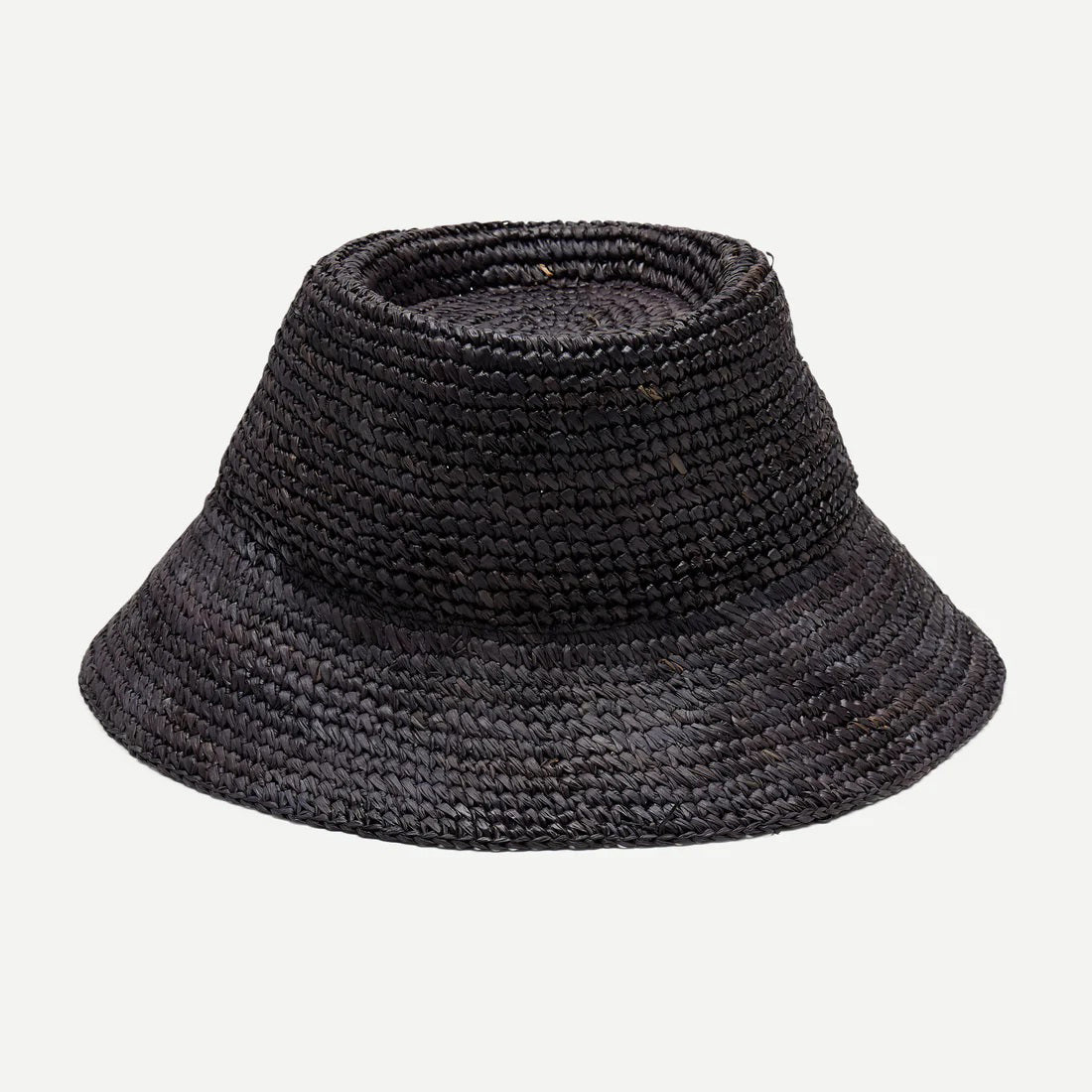 The WYETH HATS - THE TALI is a brown hand-crocheted raffia straw hat featuring a wide brim, showcased against a plain white background.