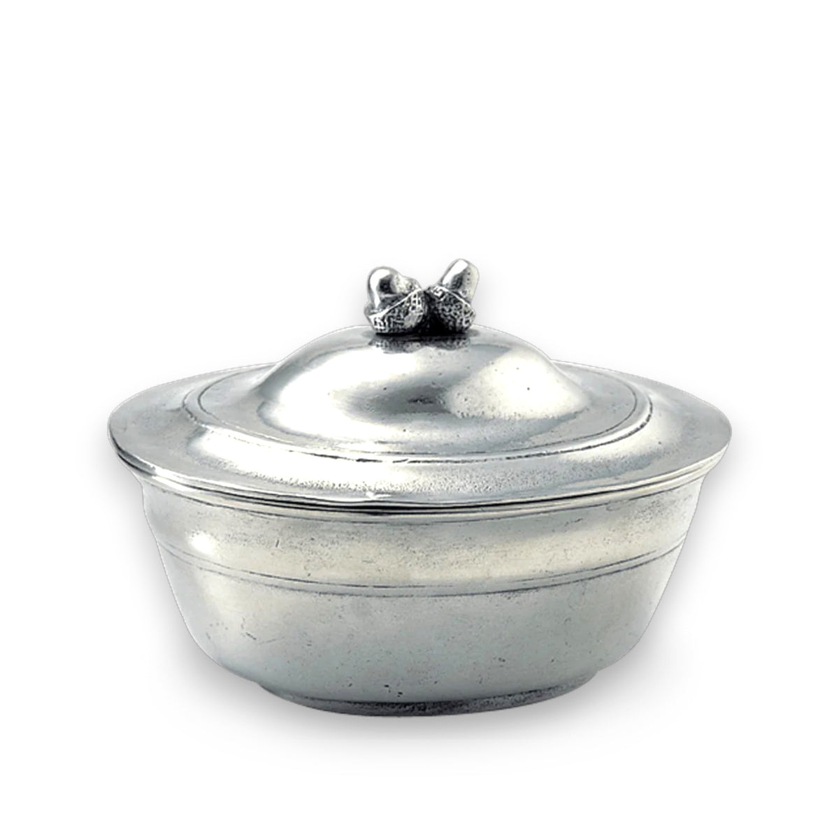 The MATCH Acorn Lidded Bowl by MATCH is a small, round pewter bowl with a matching lid, a decorative acorn-shaped handle, polished surface, and simple horizontal lines—perfect as a stylish decorative catch-all for any space.