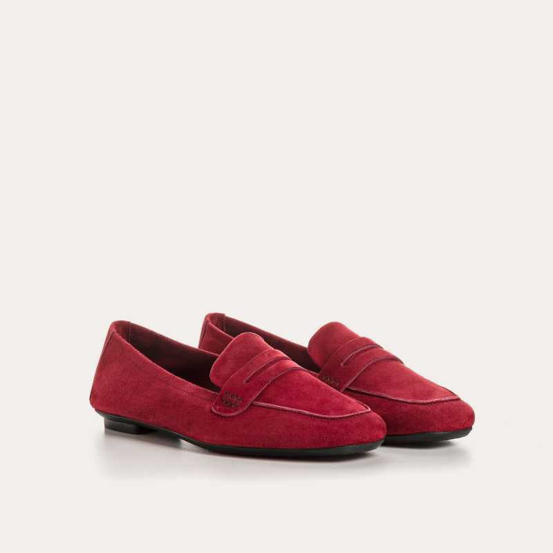 A close-up of the REQINS HEMA suede loafer in Cerise, featuring stitching details and a classic penny strap design, set against a light background.