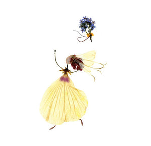 The TOSS BOUQUET BRIDAL CARD from PETAL PEOPLE PRESS showcases a charming ensemble of bride-like figures fashioned with pressed botanicals, adorned in yellow petal skirts and holding petite purple flowers, all beautifully set against a white backdrop.