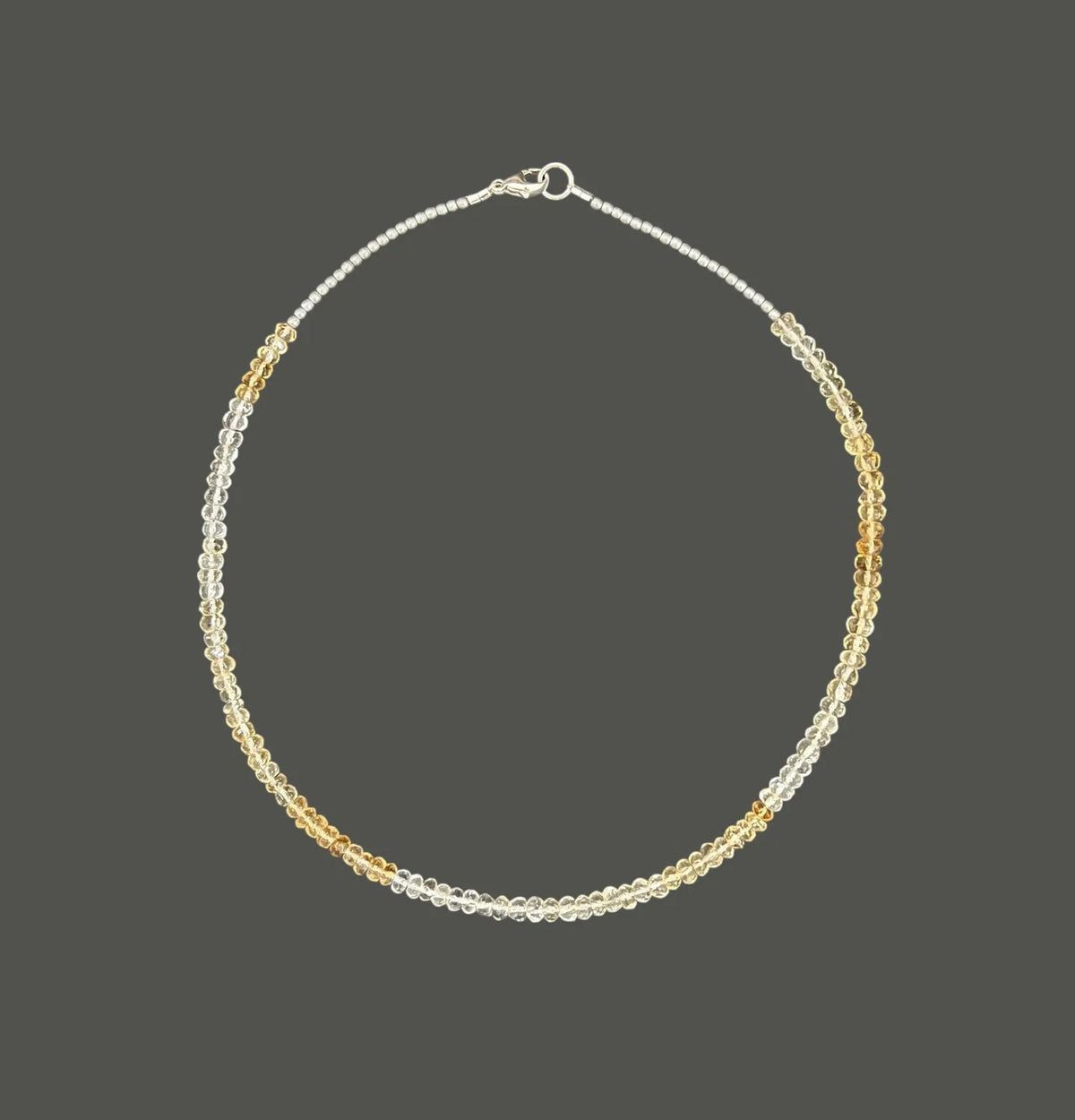 The ANN LIGHTFOOT - FACETED CITRINE RAS DU COU NECKLACE features faceted citrine stones with alternating silver and gold beads in a symmetrical design, secured by a sterling silver clasp, shown on a plain white background.