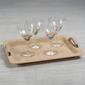 Product Description: The MARTINI COCKTAIL OPTIC GLASS set by ZODAX includes a rectangular wicker tray with metal handles, holding four stylishly crafted glass goblets, each featuring a vibrant decorative element on the stem. Ideal for serving drinks with flair, this elegant ensemble is showcased on a light gray surface.