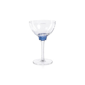 The ZODAX MARTINI COCKTAIL OPTIC GLASS is a clear glass goblet with a long stem and a wide, round bowl accented by a decorative blue detail near the base of the bowl. With a capacity of 208.5 ml, it is empty and placed against a plain white background.