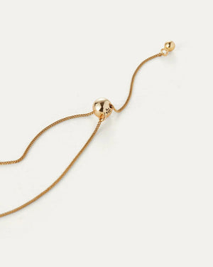 The JENNY BIRD - AURORA PENDANT NECKLACE by JENNYBIRD showcases a delicate chain with a luminous sphere pendant made from high-polish gold, displayed against a plain white background.