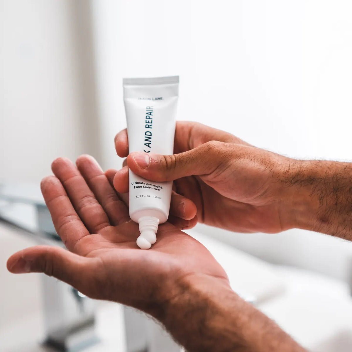 A white tube labeled &quot;JAXON LANE - RELAX AND REPAIR ANTI AGING FACE MOISTURIZER&quot; stands beside a matching black box. This fragrance-free men&#39;s moisturizer from JAXON LANE contains 2.03 fl. oz. (60 ml) of product.
