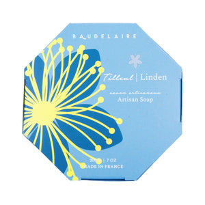 A circular bar of French-milled soap with a smooth, polished surface. The BAUDELAIRE - LINDEN 7OZ BOXED BATH BAR, enriched with shea butter, has an embossed label in the center that reads "PROVENÇAL SANTÉ 200g.