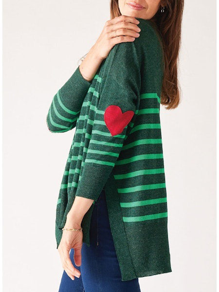 The MERSEA - AMOUR SWEATER WITH HEART PATCH from MER SEA showcases a dark green design with horizontal light green stripes and a charming red heart appliqué on the elbow. This piece exudes French fashion sophistication when matched with stylish blue pants.