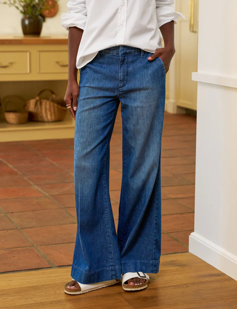 The FRANK &amp; EILEEN West Village NYC Wide Leg Trouser in Italian Dream Light Denim 1986 Wash features front pleats and belt loops, shown flat against a white background for a chic New York City-inspired style.