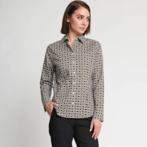 A person with short brown hair is wearing the HINSON WU - DIANE LONG SLEEVE FITTED SHIRT, showcasing tile-inspired prints, along with black pants. They are standing against a plain white background, looking slightly to the side with one hand in their pocket. The fitted style of the shirt from HINSON WU adds to their sharp appearance.