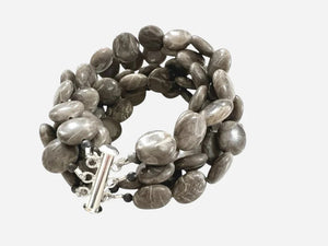 The ANN LIGHTFOOT Brown Jasper Coin Five Strand Bracelet features chunky, polished brown jasper stones and a stainless steel clasp, shown on a plain white background.
