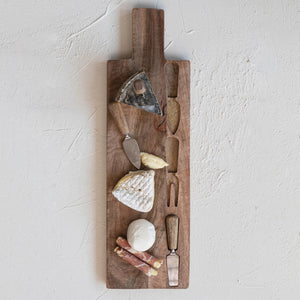 The CHEESE CUTTING BOARD WITH UTENSILS by CREATIVE COOP offers a rectangular mango wood board with a handle, featuring three eco-friendly utensils—spreader, fork, and knife—that align beautifully on its surface. The board also showcases the natural wood grain texture.