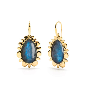 Introducing the CAPUCINE DE WULF - BLISS DROP BLUE LABRADORITE EARRINGS by CAPUCINE DE WULF. These elegant teardrop-shaped earrings are meticulously crafted with blue and black labradorite stones encased in an 18K Gold IP petal-like design, hanging gracefully from simple gold hooks. This piece of handmade jewelry is perfect for adding a touch of sophistication to any ensemble.