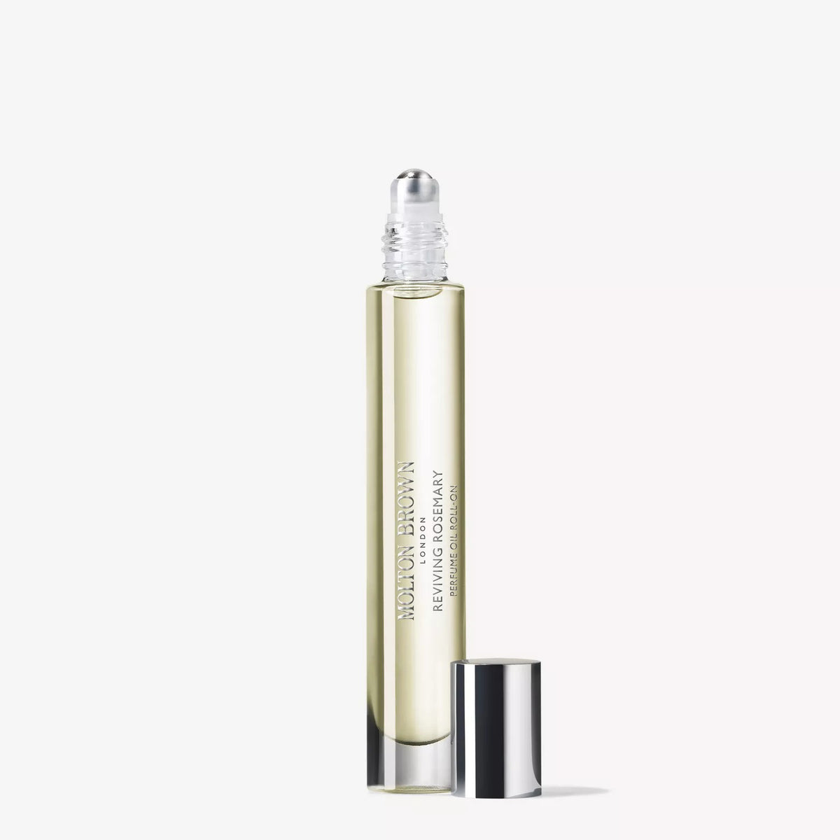 A clear glass rollerball bottle filled with pale yellow liquid, labeled &quot;MOLTON BROWN REVIVING ROSEMARY TRAVEL PERFUME OIL .33FLOZ,&quot; stands upright with its shiny silver cap beside it on a plain white background.