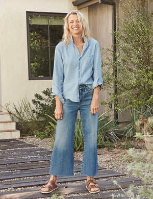 The FRANK & EILEEN Galway Gaucho Jean in the 1972 Wash offers a high-waisted, wide-leg design with a subtle faded effect and classic five-pocket styling, perfectly embodying the spirit of Italian Dream Denim. Featuring a raw hem for that iconic gaucho-style, these light blue jeans are showcased against a lightly textured background.