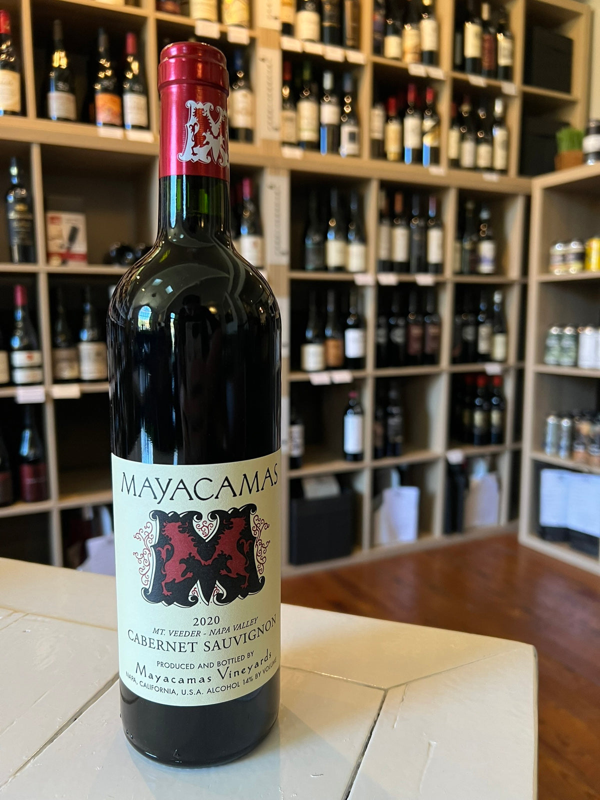 A bottle of MAYACAMAS CABERNET SAUVIGNON 2020 from WINE: KELLOGG SELECTIONS, featuring a red foil top, cream label, and bold red &quot;M&quot;—an outstanding Napa Valley wine.