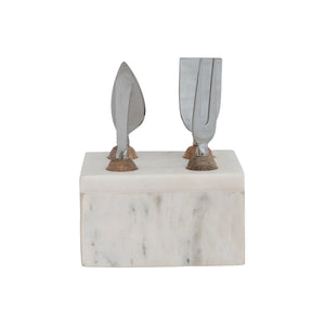 The MARBLE CHEESE SERVER STAND by CREATIVE COOP elegantly displays four stainless steel cheese knives with wooden accents. With artisanal design and unique blades, these servers stand upright against a white backdrop, epitomizing modern elegance in serve ware.