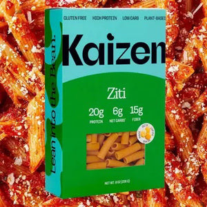 A box of KAIZEN brand Ziti pasta. The turquoise and green box, adorned with "KAIZEN FOOD COMPANY" in bold black letters and "Ziti" in white, highlights attributes like "Gluten-Free," "High-Protein," "Low-Carb," and "Plant-Based." Inside is the gluten-free pasta, clearly visible through the packaging.