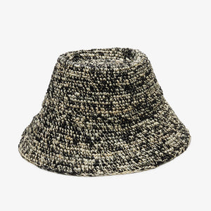 The WYETH HATS - THE LOLO is a hand-crocheted textured woven bucket hat by WYETH, featuring black, white, and beige on a plain white backdrop. The customizable fit ensures comfort while showcasing style.