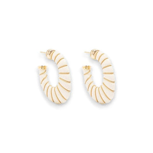 Introducing the Cyclade Hoop Earrings from Gas Bijoux, a stunning piece of French haute-fantaisie jewelry. These earrings feature a mesmerizing spiraling design with predominantly white enamel, accented by 24K gold-plated stripes that encircle their circumference. Ideal for pierced ears, they boast secure post back closures.