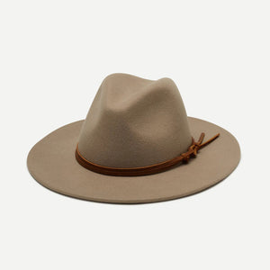 The BILLIE FEDORA HAT by WYETH is a tan wool felt fedora with a leather trim, showcasing a pinched crown and mid brim, beautifully displayed against a plain white background.