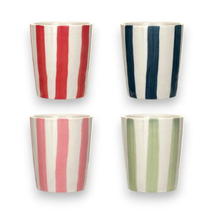 The CREATIVE COOP STONEWARE CUP WITH STRIPES, featuring four hand-painted cups with vertical stripes in red, dark blue, pink, and green on a crisp white background, are arranged in a 2x2 grid.