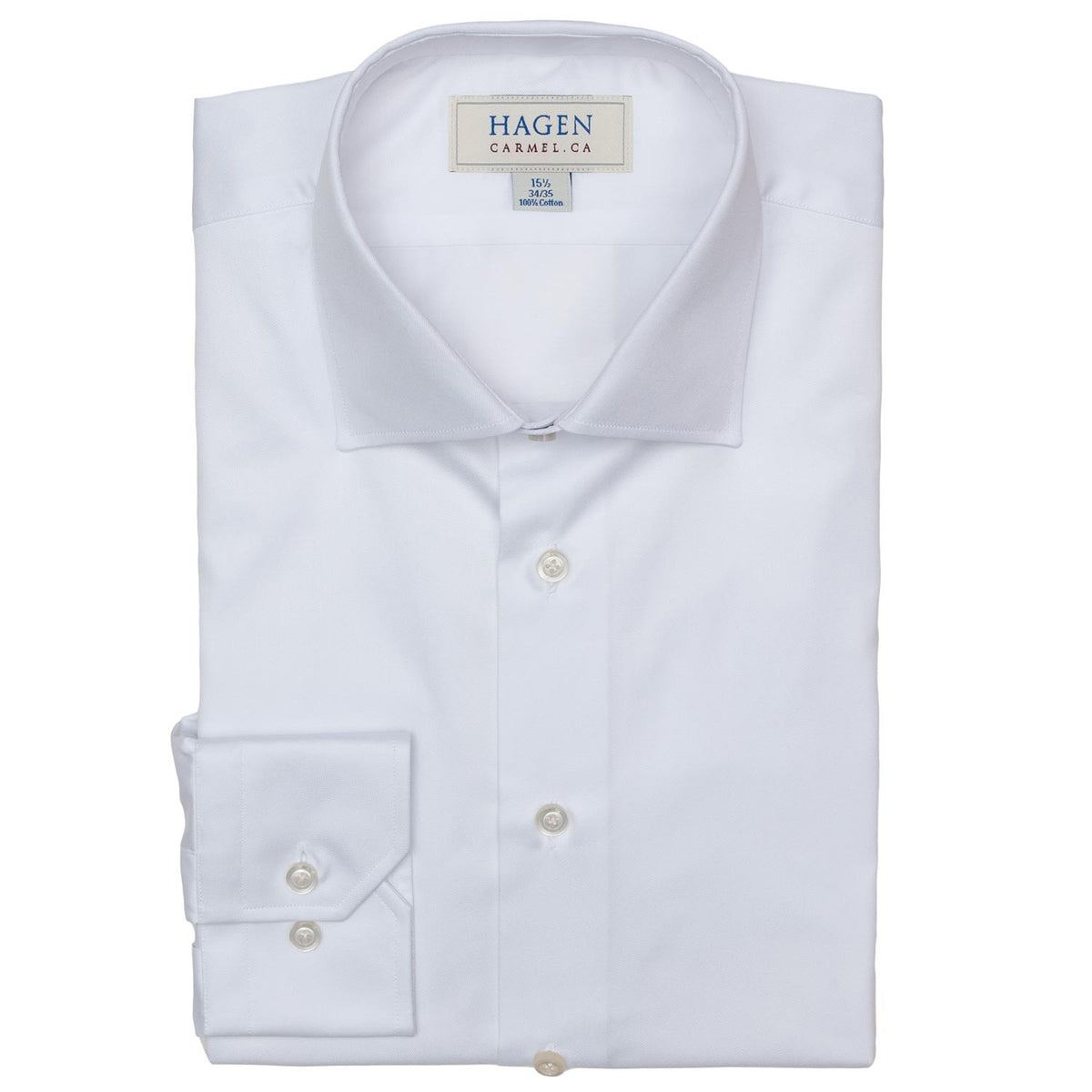 The HAGEN - COTTON DRESS SHIRT IN WHITE features premium cotton, a modern spread collar, and buttoned cuffs. The shirt displays the &quot;HAGEN&quot; brand label and is shown neatly folded against a plain white background.