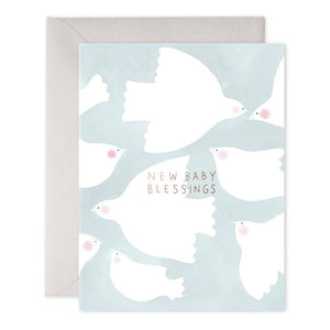 The E.FRANCES PAPER BABY BLESSINGS GREETING CARD showcases handcrafted artistry with graceful white doves soaring against a soft blue background. The center shines with the words "New Baby Blessings" in shimmering gold, complemented by an envelope tucked behind. Proudly made in the USA, it’s an ideal keepsake for celebrating new beginnings.