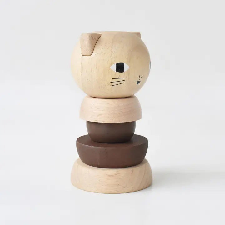 The WEE GALLERY - CAT WOOD STACKER by WEE GALLERY is a wooden stacking toy designed to resemble a cat, crafted from sustainable rubberwood with painted facial features. It consists of smooth, rounded pieces in natural and dark brown tones, offering a minimalist figure that not only entertains children but also aids in developing fine motor skills. The background is plain white.