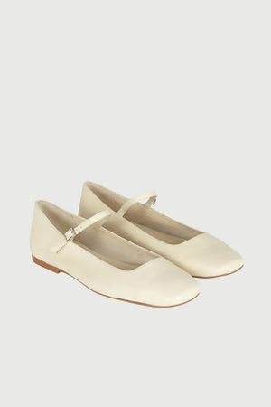 The AUGUSTA - JULIETA MARY JANE by AUGUSTA is a black leather flat shoe featuring a slender, adjustable strap across the top and a low wooden heel. With its renewed silhouette, slightly pointed toe, and minimalist design, this handcrafted Spanish shoe is presented against a plain, light gray background.