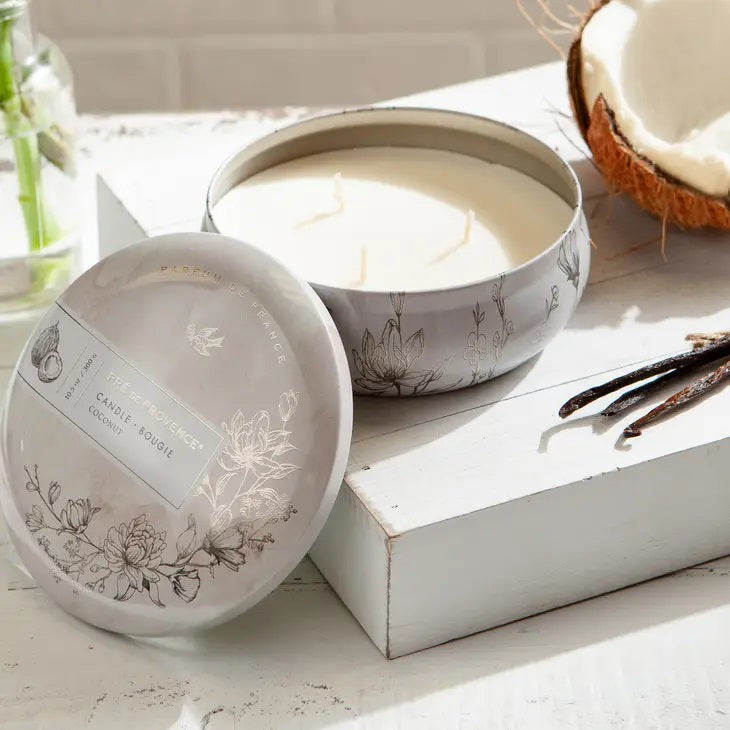 The &quot;3 Wick Candle - Coconut&quot; from European Soaps, LLC boasts an enchanting coconut and white gardenia scent in a circular tin adorned with black and white illustrations of flowers and a bird. The cover prominently displays &quot;PARFUM DE FRANCE,&quot; &quot;10.5 OZ / 300 G,&quot; and &quot;CANDLE • BOUGIE.