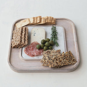 The MANGO WOOD SERVING BOARD WITH MARBLE INSERT by CREATIVE COOP exudes rustic elegance, featuring an assortment of crackers, cheese slices, salami, green olives, and a rosemary sprig neatly displayed on the white marble slab.