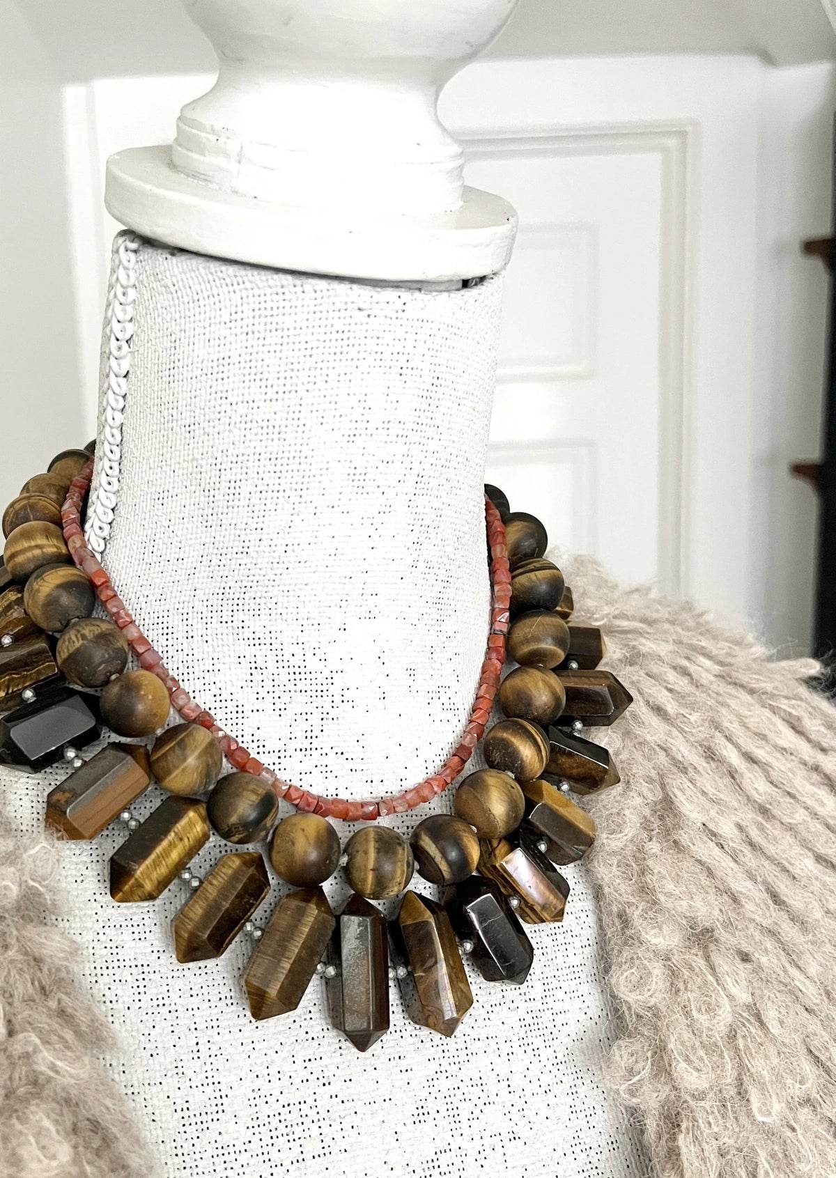 The ANN LIGHTFOOT - TIGER EYE DOUBLE POINTS RAS DU COU NECKLACE features striking brown and gold faceted tiger eye gemstones, symmetrically arranged and finished with a sterling silver clasp for an elegant look.