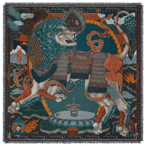 The SABINA SAVAGE - THE SNOW LION SILK TWILL SCARF 135CM by SABINA SAVAGE ENGLAND is a luxurious silk scarf featuring an intricate design in rich browns, blues, and oranges. The pattern, inspired by Tibetan thangkas, includes ornate architectural elements, flowing red hair, and winged figures, all accented by fine detailing and a fringed edge.