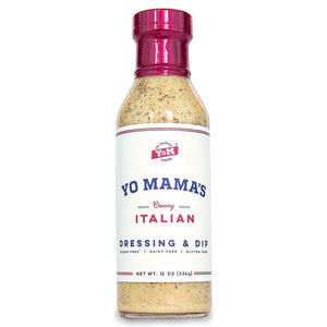 A 12-ounce bottle of YO MAMA'S - CREAMY ITALIAN DRESSING by YO MAMA'S FOODS, featuring a red cap and a white label with blue and red text. The label proudly states that the dressing is gluten-free, dairy-free, and contains no added sugar. Specks of seasoning are visible in the creamy dressing.