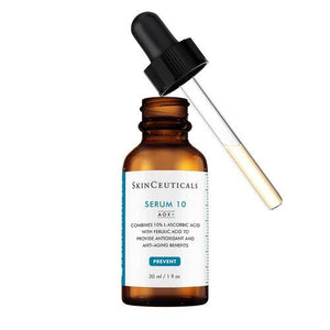 A brown dropper bottle labeled "SKINCEUTICALS - SERUM 10 AOX" stands against a white background. The label mentions it combines 10% L-ascorbic acid with ferulic acid to provide antioxidant and anti-aging benefits for sensitive skin, and the bottle contains 30 ml (1 fl oz) of product.