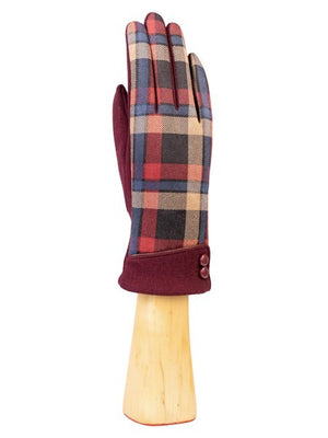 The KNIT CHECKERED GLOVE by SANTACANA MADRID WORLD GLOVE COMPANY is elegantly displayed on a wooden hand stand, showcasing its plaid pattern in shades of brown, gray, and black. This knitted women's glove provides comfort and warmth with its dark cuff accented by two dark buttons.