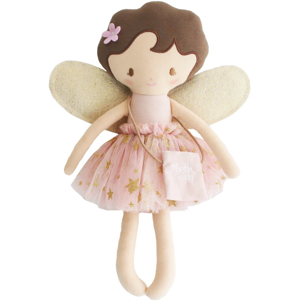 The ALIMROSE - TILLY THE TOOTHFAIRY IN GOLD BLUSH from ALIMROSE is a soft toy doll dressed as a tooth fairy. It features brown hair, a pink flower hair accessory, and glittery wings. Wearing a pink dress adorned with golden stars and a removable tutu, it holds a small bag labeled &quot;Tooth Fairy.&quot; The doll has a cheerful expression with stitched features.