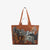 The INOUI EDITIONS MAXI WESTERN SHOPPER BAG from INOUI is a large brown tote with long handles, adorned with an artistic print of various multicolored horses in motion. Crafted from recycled polyester, it features shades of black, white, grey, and brown. This eco-friendly bag boasts a smooth, polished finish and is lightweight for easy carrying.