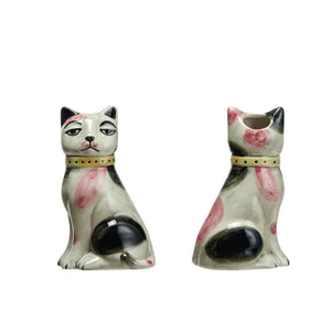 The CAT VASE by CREATIVE COOP is a pair of ceramic cat-shaped salt and pepper shakers with crackle glaze, featuring one sleepy expression and one backward-facing, adorned with black, white, and pink spots plus yellow collars, reflecting hand-painted stoneware artistry.