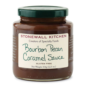 A jar of STONEWALL KITCHEN- BOURBON PECAN CRAMEL SAUCE with a dark green lid, featuring a white label. The label reads "STONEWALL KITCHEN, Creators of Specialty Foods, Bourbon Pecan Caramel Sauce, Gluten Free, Net Weight 354g (12.5 oz)." Perfect for elevating any dessert with rich caramel sauce and crunchy pecan pieces.