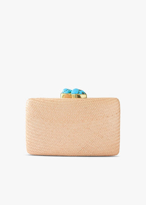 The KAYU Jen Clutch features a chic Buntal straw design with a gold clasp and vibrant turquoise stones. Its rectangular shape and textured surface are elegantly showcased against a white background, exemplifying stylish simplicity.