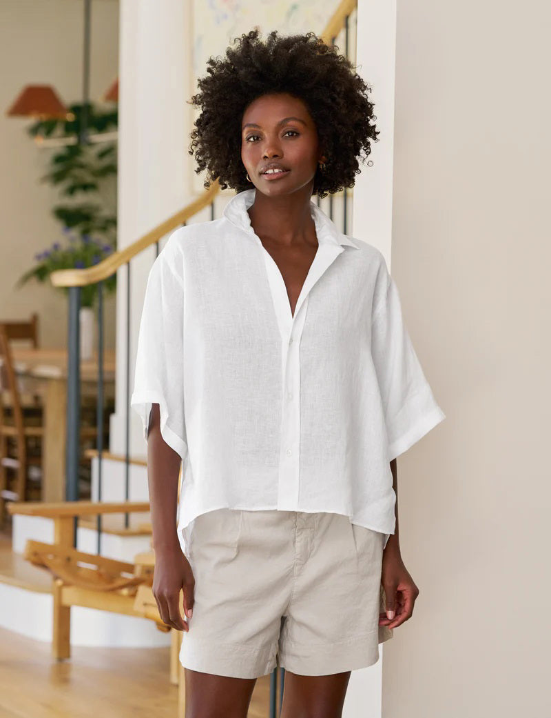 The FRANK &amp; EILEEN Rosie Short Sleeve Button Up Shirt in white linen features a wide collar, loose fit, and &quot;Frank &amp; Eileen&quot; label inside the collar. This women&#39;s shirt is shown on a white background.