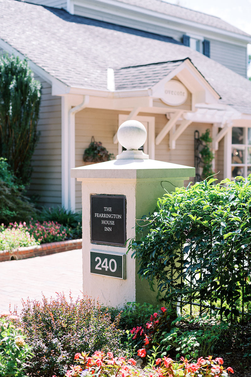 A stone pillar with a sign reading 