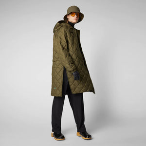 A person wearing the SAVE THE DUCK - VALERIAN PUFFER COAT in olive-green from the Recycled collection, along with a hood, black gloves, sunglasses, a bucket hat, black pants, and clogs. They are standing sideways and looking at the camera against a plain gray background.