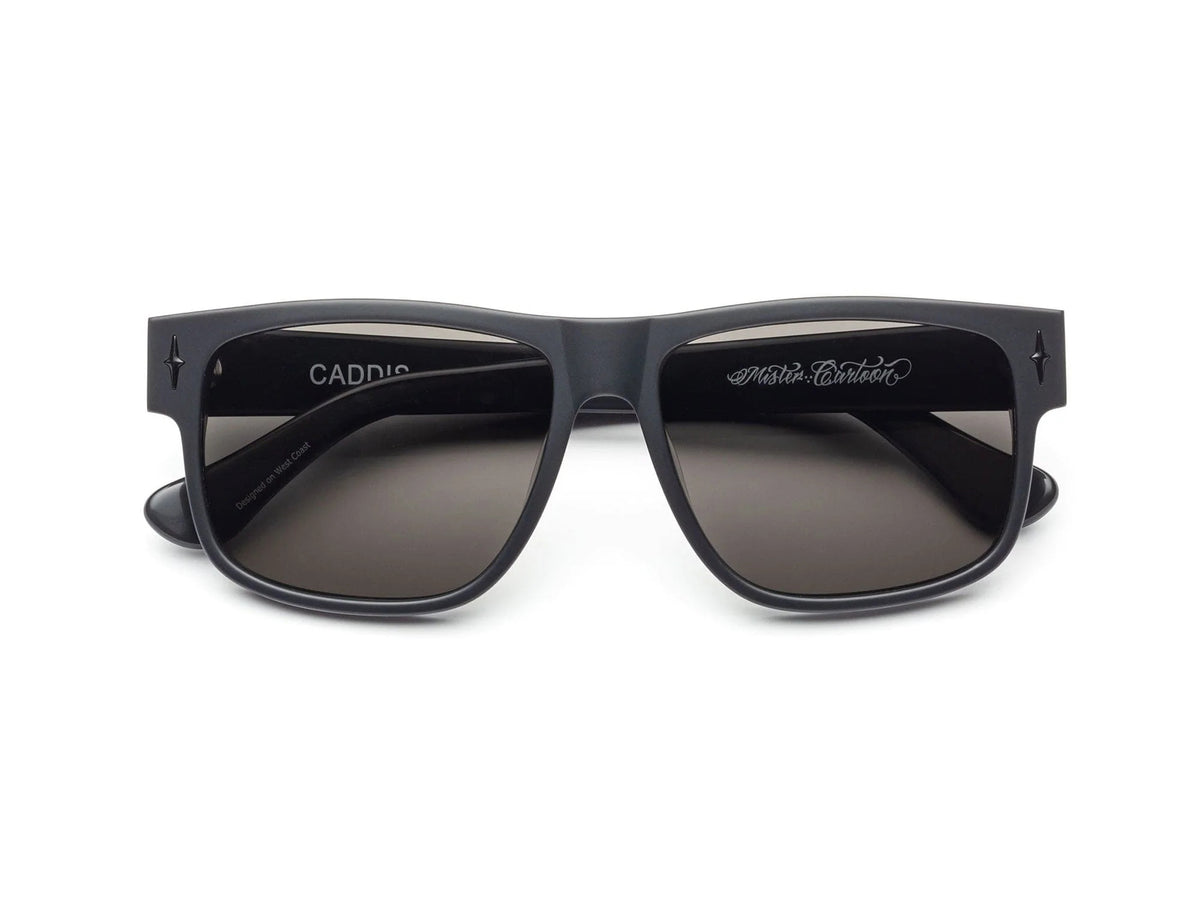 Front view of CADDIS - MISTER CARTOON matte black square sunglasses with dark lenses, premium acetate frame, and &quot;CADDIS&quot; branding inside the left arm.