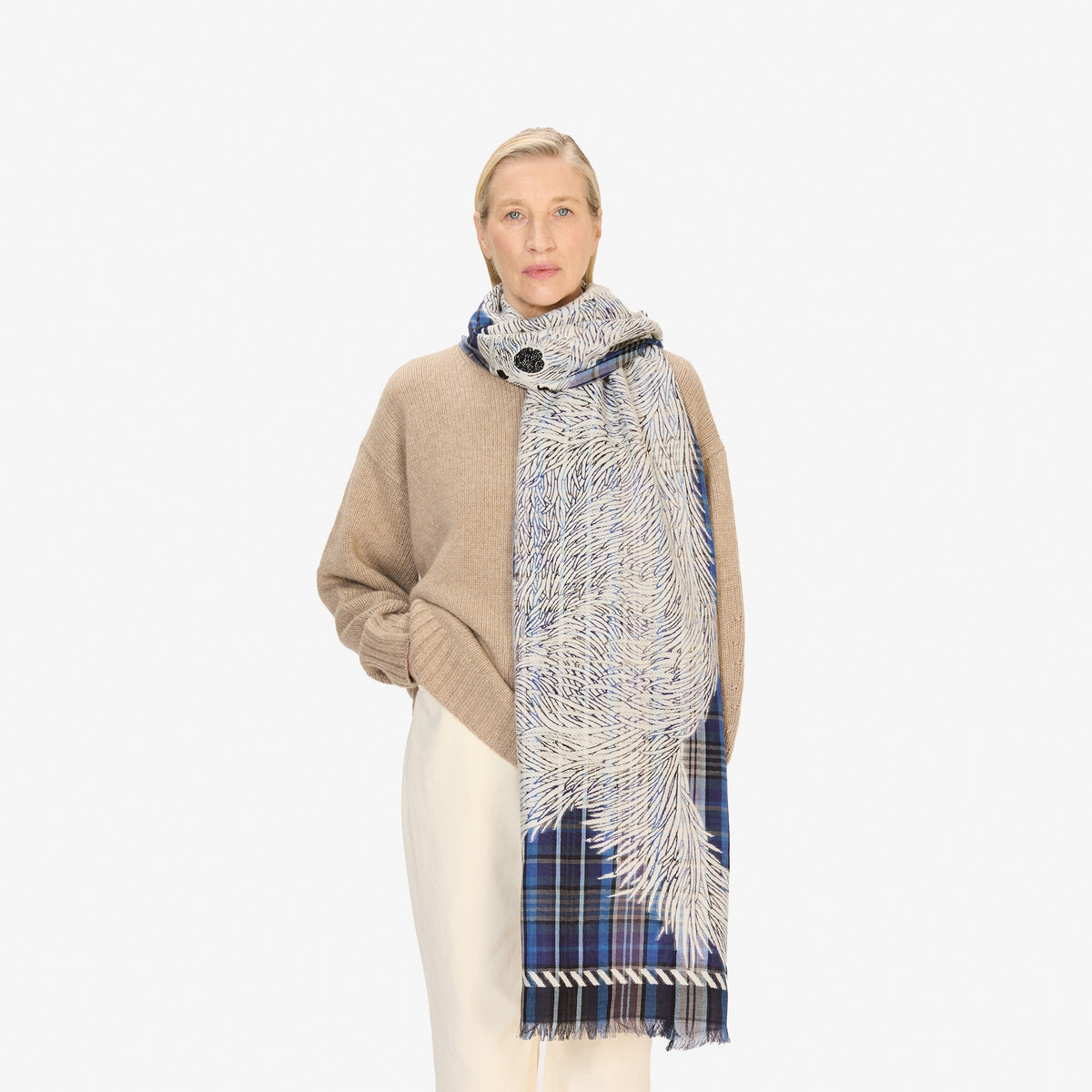 The INOUI FREDDY DOG SCARF IN 3D BLUE by INOUI is a rectangular, blue plaid wool-cotton scarf featuring white sketch-like dog drawings and fringed edges on both short sides, made in India.