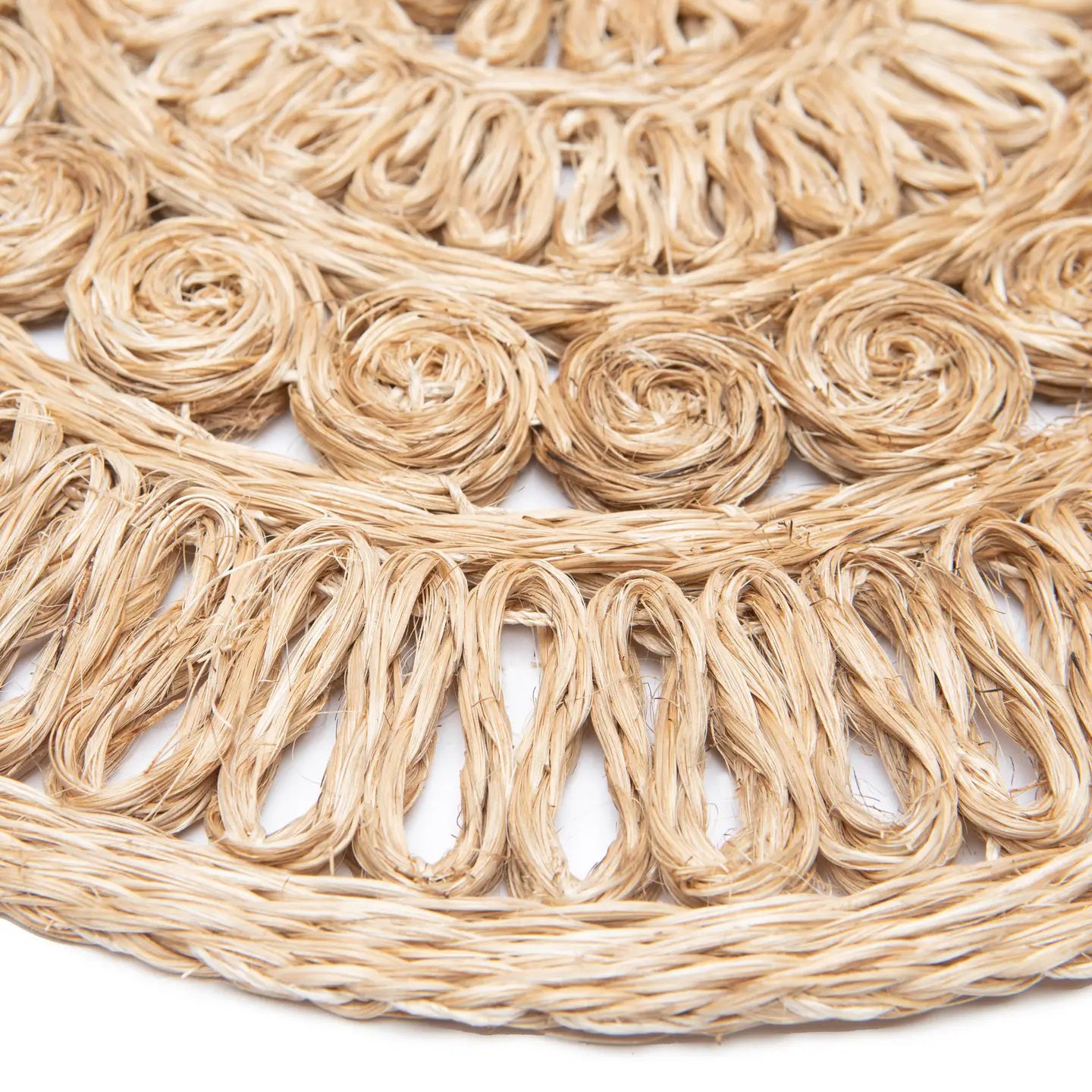 Close-up of a CIRCOLO ABACA ROUND PLACEMAT by COULEUR NATURE, featuring intricately handwoven circular and loop patterns. The coarse texture showcases shades of beige and brown, highlighting the artistry typical of natural abaca woven placemats.