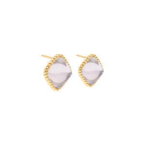 The CAPUCINE DE WULF - BLANDINE STUD EARRINGS IN ICE GOLD by CAPUCINE DE WULF are a pair of handmade crystal stud earrings, featuring diamond-shaped light purple gemstones encased in a gold twisted rope design setting. Crafted in 18K Gold IP, these elegant earrings have gold posts and are displayed against a plain white background.