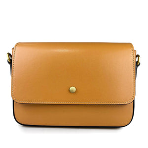 The RIGID LEATHER HANDBAG by MIRAMI FIRENZE is a cream-colored leather handbag with a minimalist design. It features a flap closure with a single metallic button in the center, black edging, brass hardware on the strap attachments, and an adjustable shoulder strap for versatility. Crafted from real leather, it also includes internal pockets for organization.