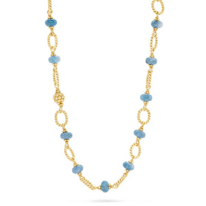 The CAPUCINE DE WULF - BERRY & BEAD NECKLACE WITH OCEAN JADE by CAPUCINE DE WULF is a long, lariat-style gold necklace featuring alternating twisted gold links and round ocean jade stones. The design is repeated with some segments containing textured gold beads. This versatile necklace has an elegant and intricate pattern, making it perfect for any occasion.